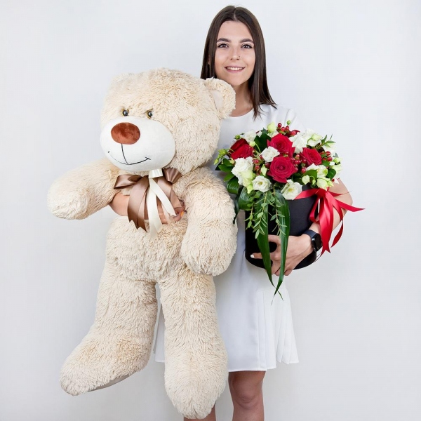 Red rose 50 cm - 12, lisianthus - 7, Round flower box medium, Oasis, Film, Ruscus, Aspidistra (1 pc.), Hypericum, Eucalyptus parvifolia (1 pc.), Teddy bear 70 cm, Ribbon