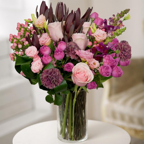 Pink Lisianthus (Eustoma) - 2, Matthiola Lilac - 3, Bright pink spray rose mix, 50 cm - 7, Pink rose 50 cm - 5, Pink carnation - 4, Leukodendron, Hypericum, Aspidistra (1 pc.), Wrapping Paper